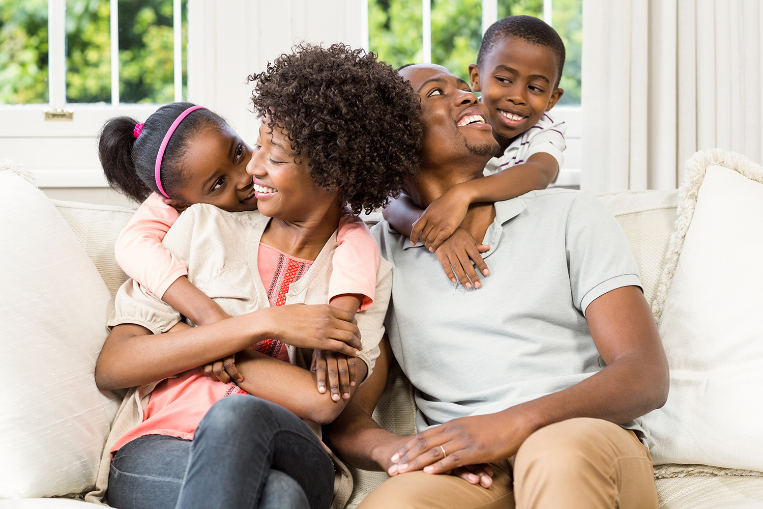 Smiling family sitting on the couch together